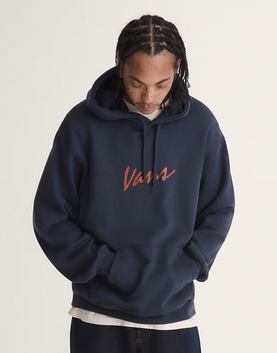 A man wearing a Script logo hoodie in a photography studio.