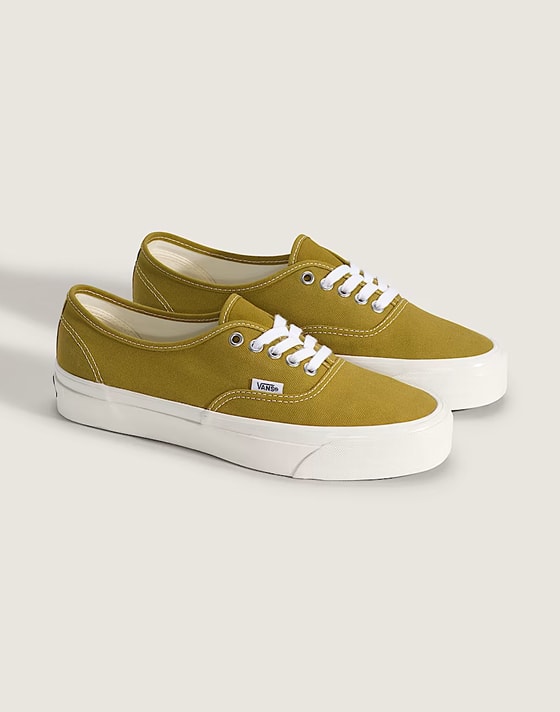 A pair of mustard yellow Authentic in a photography studio.