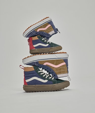 Color-blocked Kids’ Sk8Hi stacked vertically in a photography studio.