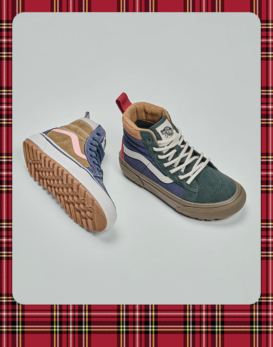 A photograph surrounded by a plaid holiday border of a pair of color-blocked Kids’ Sk8Hi in a photography studio.