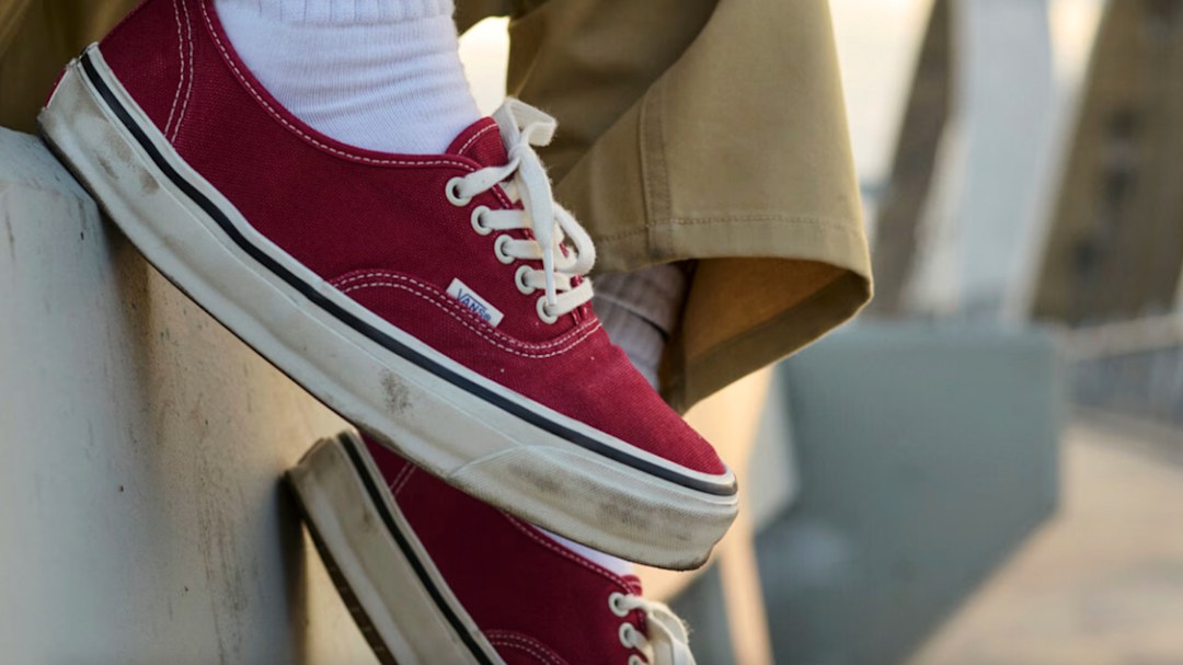 Someone wearing red Authentic Vans shoes.