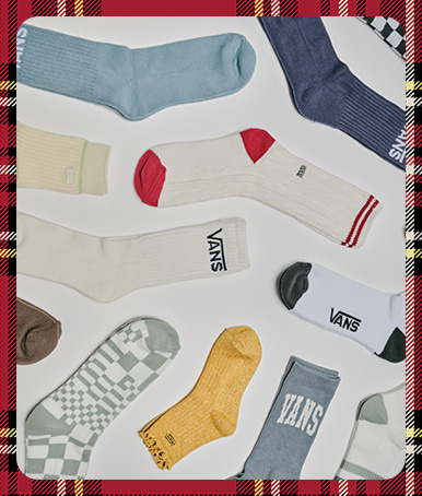 An array of Vans socks spread out on the floor of a photography studio floor.