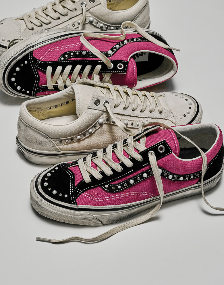 Two people standing in a photography studio wearing the white colorway and the magenta and black colorway of the Premium Old Skool 36 Pearlized.