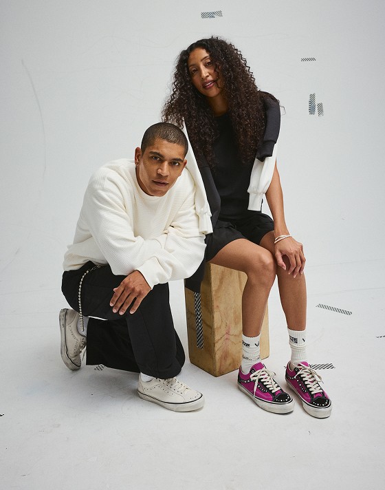 A young man and woman pose in a photography studio wearing the Premium Old Skool 36 Pearlized shoes.