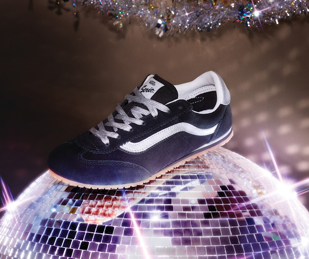 A navy and white Super Lowpro shoe rests on top of a twinkling disco ball.