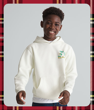 A plaid holiday border around an image of a young boy wearing a Kids Lazy Daze Pullover Sweatshirt in a photography studio.