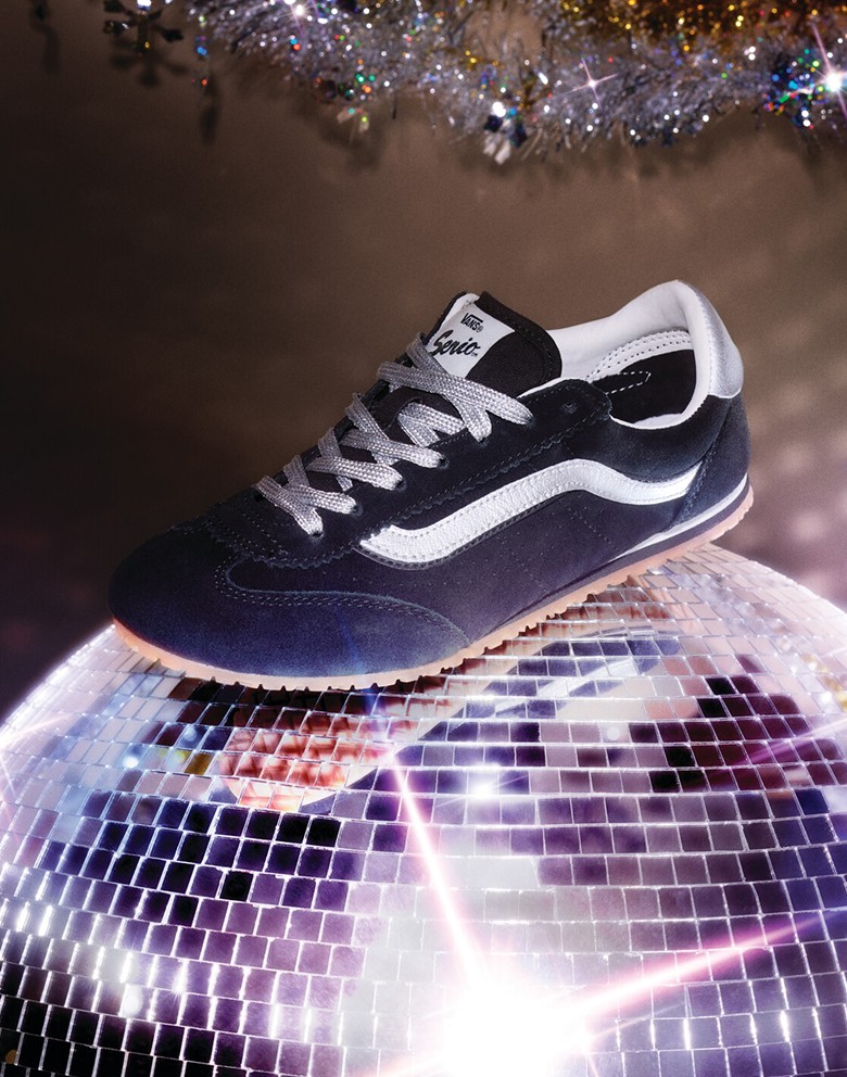 A navy and white Super Lowpro shoe rests on top of a twinkling disco ball.
