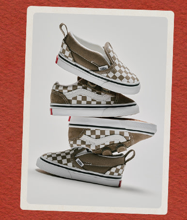 Several pairs of brown and white Checkerboard kids’ shoes stacked on top of each other on a red holiday background.