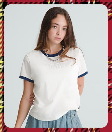 Holiday border with a woman in a grey photography studio wearing Drop V Ringer T-Shirt in Marshmallow White