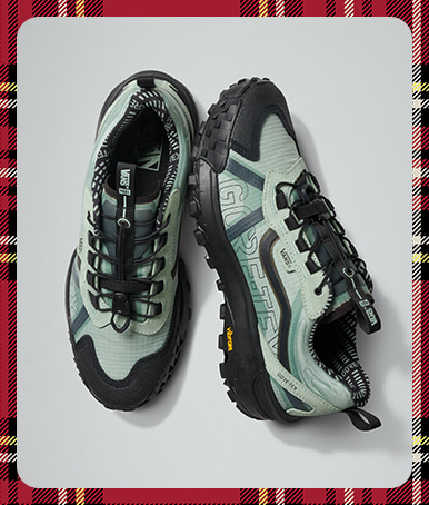 Close up of the Crosspath XC GORE-TEX Shoe in Dusty Olive Blue with a grey background in a photography studio.