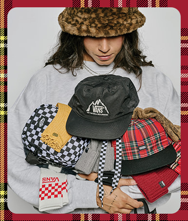 A photograph surrounded by a plaid holiday border of a young woman wearing a leopard print Hildy Bucket Hat and holding a variety of hats and socks.