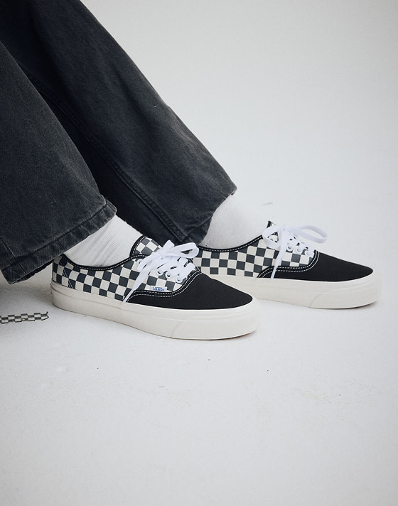 Close up of a man wearing Premium Authentic Checkerboard Shoe in Checkerboard Asphalt Grey / White.