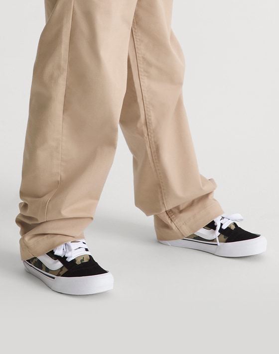 Kid wearing Little Kids Knu Skool Shoe in Camo Jungle Green.