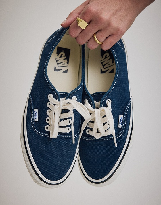 Person holding a pair of the Premium Authentic Shoe in Parisian Night Blue.