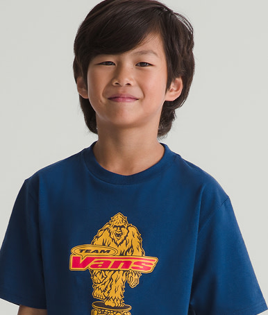 Kid wearing a Kids Big Push T-Shirt in Deep Indigo Blue in agrey photography studio.