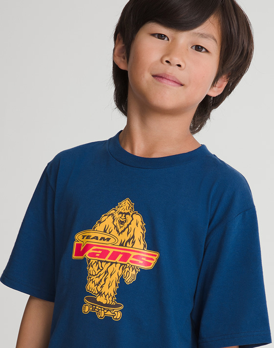 Kid wearing a Kids Big Push T-Shirt in Deep Indigo Blue in agrey photography studio.