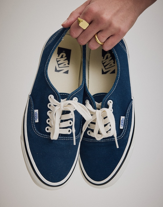 Person holding a pair of the Premium Authentic Shoe in Parisian Night Blue.