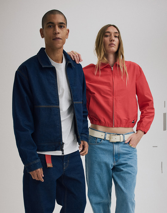 Medium shot of a woman in a Racing Red Lightweight Bomber Jacket and a man in a Premium Denim Station Jacket.