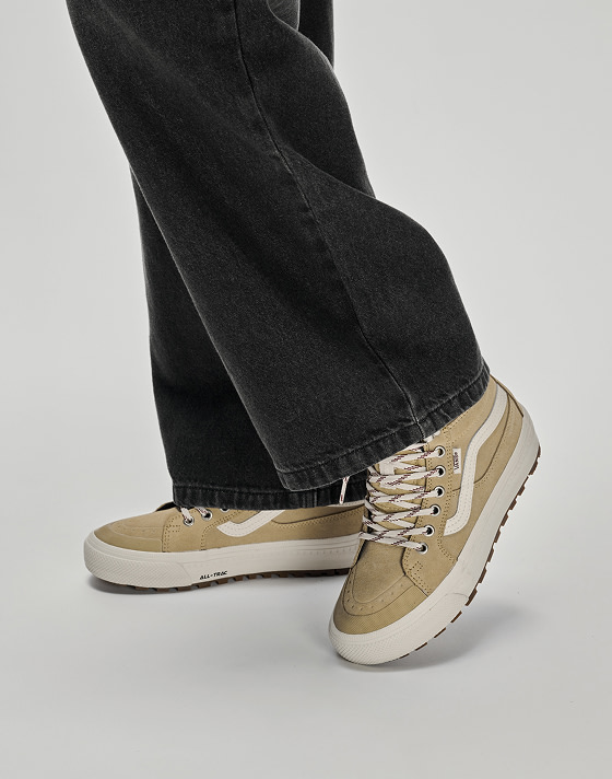 Image of someone wearing the Sk8-Hi Waterproof Insulated Shoe in Brown / White with black jeans on.