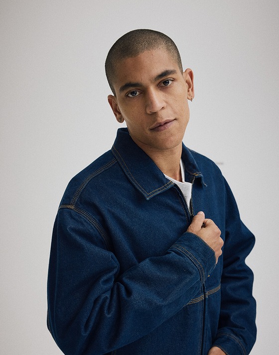 Medium shot of a man wearing a Premium Denim Station Jacket.