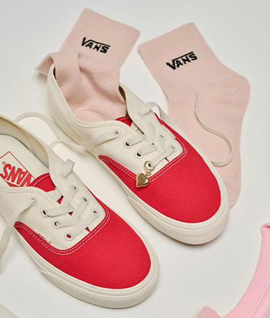 A pair of red and white Authentic with pink Vans crew socks from the Vans Valentine’s Day Collection.