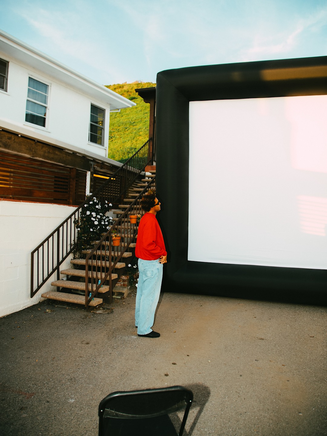 Mikey February staring at the projection screen in the parking lot of Brothers Marshall.