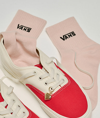 A pair of red and white Authentic with pink Vans crew socks from the Vans Valentine’s Day Collection.