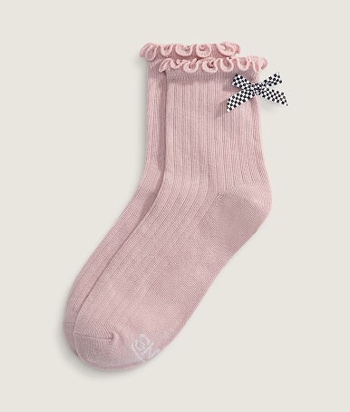 A pair of sepia rose pink Bow Back Crew Socks in a photography studio.