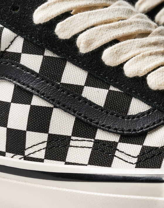Extreme close up of the Premium Old Skool Checkerboard in black and white focusing on the sidestripe and fine stitching.