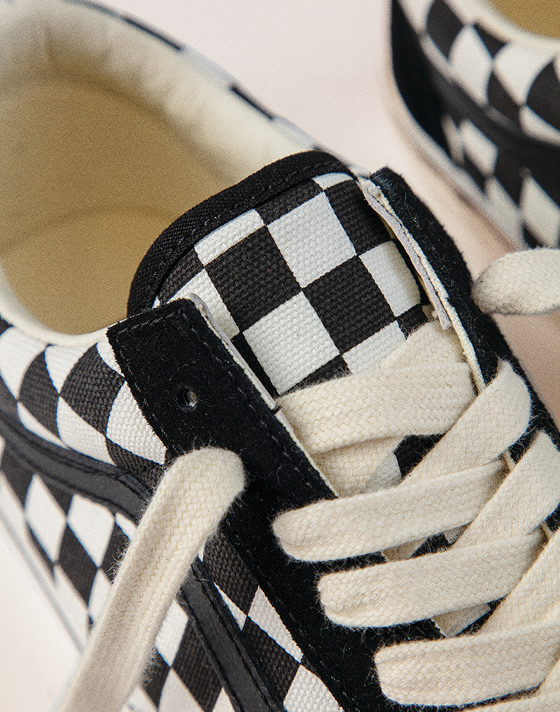 Extreme close up of the Premium Old Skool Checkerboard in black and white focusing on the tongue and the checkered print.