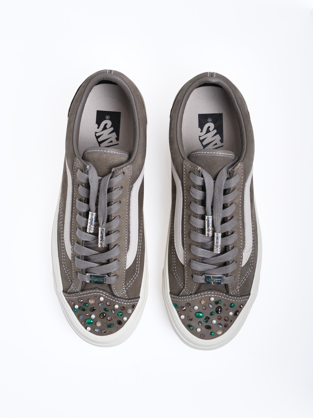 Rachel Goatley bedazzles a brown Vans shoe, shown on a white background.