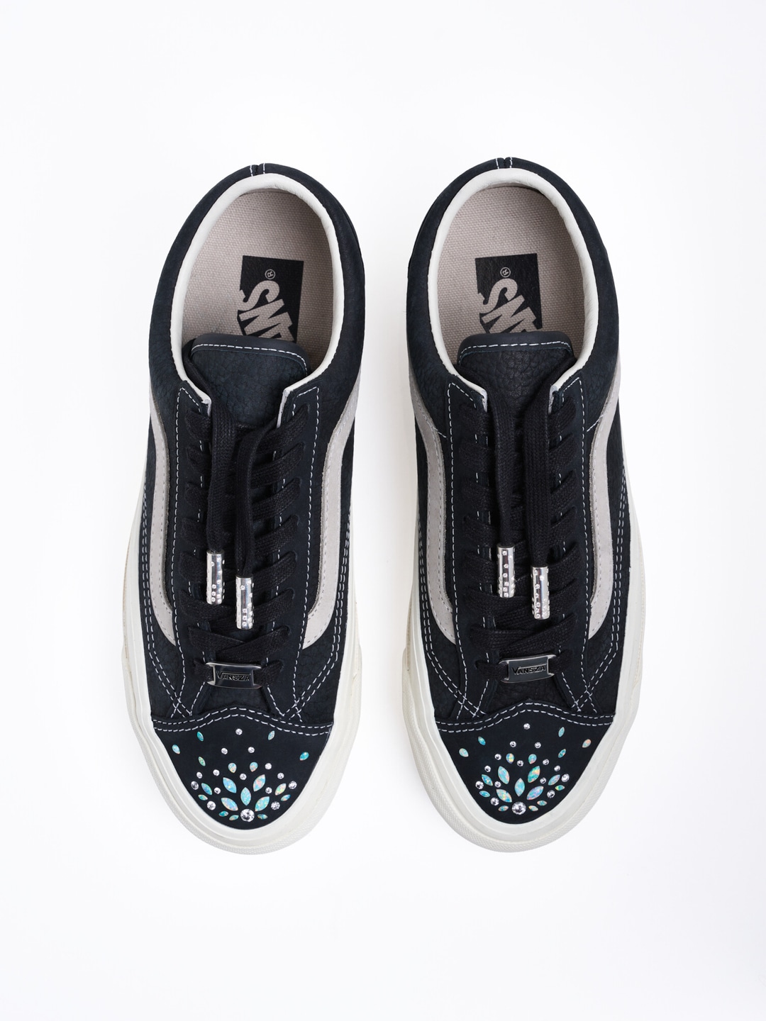 Rachel Goatley bedazzles a black Vans shoe, shown on a white background.