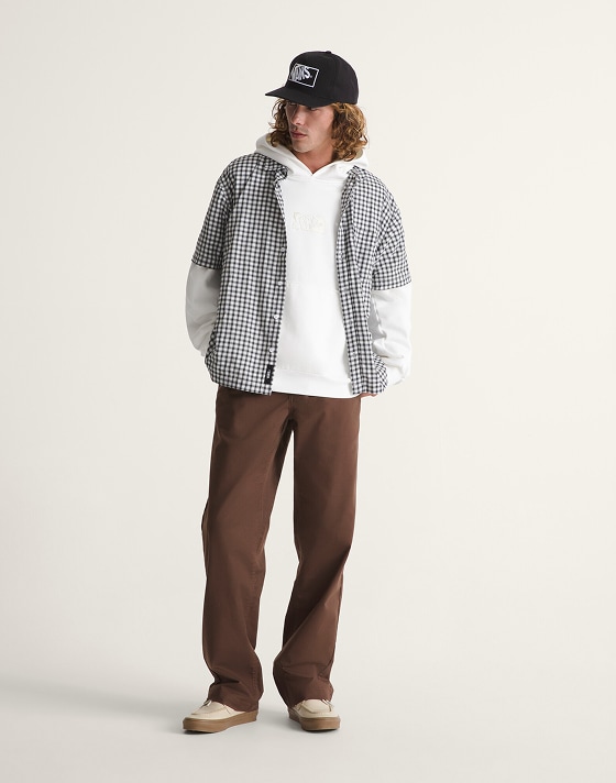 Full body shot. Man wearing a Plaid Shirt over a White Premium Pullover﻿ with a Black Hat﻿, Brown Straight Chinos and Brown Boat Shoe.