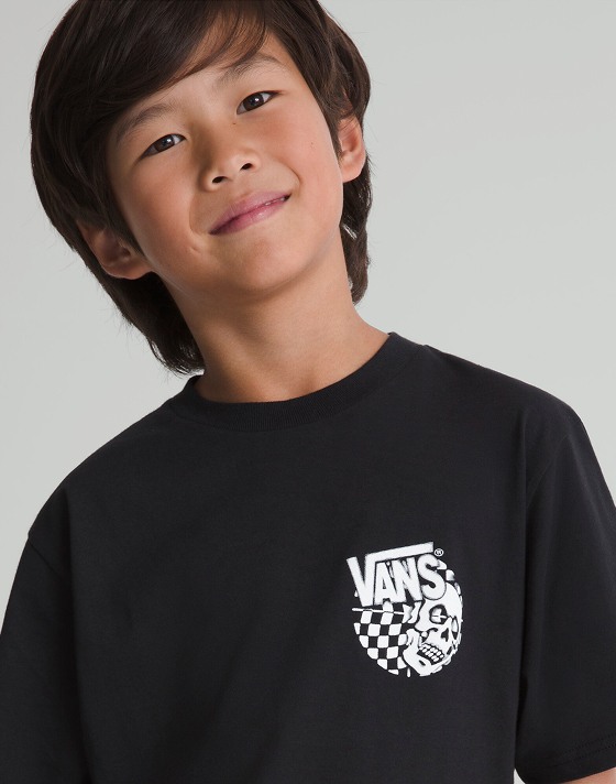 Close-up chest-up shot of a kid wearing a black Kids Representative T-Shirt in a grey photography studio.