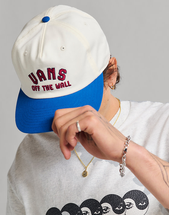 Medium shot of a man wearing a Vans Design Co. Low Hat in true blue / white.