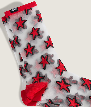 Close up of the Hazy Sheer Crew Socks in Racing Red on the floor of a grey photography studio.