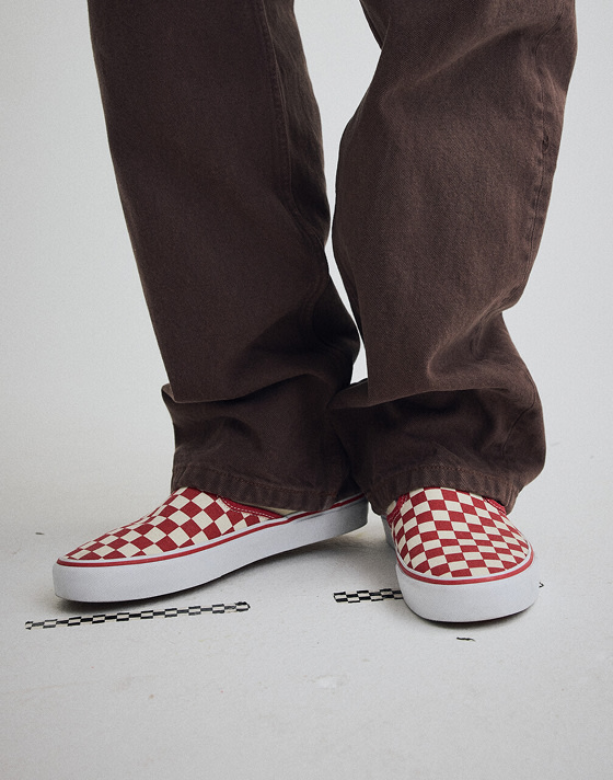 Close up of someone wearing the Demitasse Brown Super Lowpro shoes while kicking their feet up on the end of a couch.
