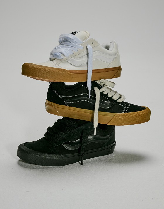Three Knu Skool Shoes stacked on top of one another. Top is the Blanc De Blanc White, middle is the Gum Black, bottom is the Black.