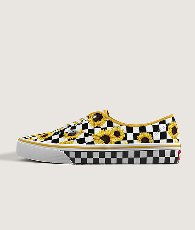 Medium shot of a pair of the custom Authentic with Sunflowers and white and black checkerboard print sitting on the floor of a grey studio.