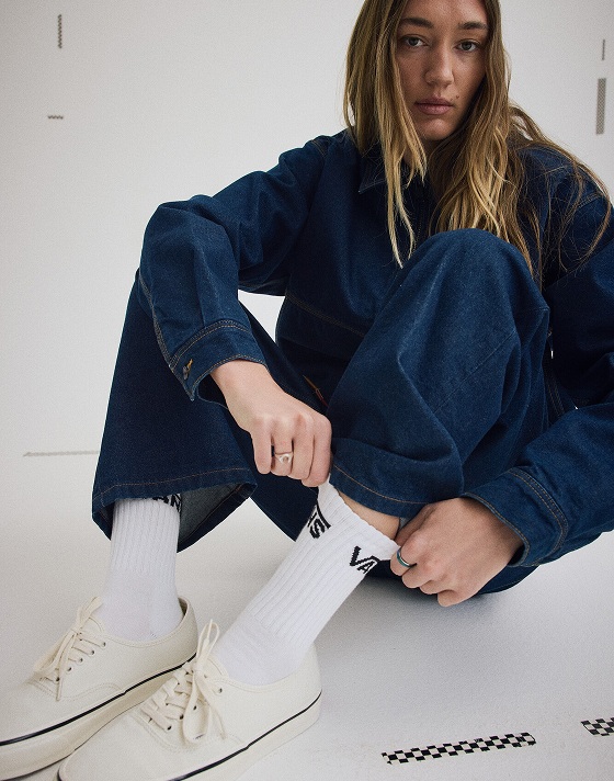 Medium shot a woman wearing the Premium Denim Station Jacket with Premium Check-5 Loose Denim Pants and a pair of Marshmallow Premium Authentic Shoes.