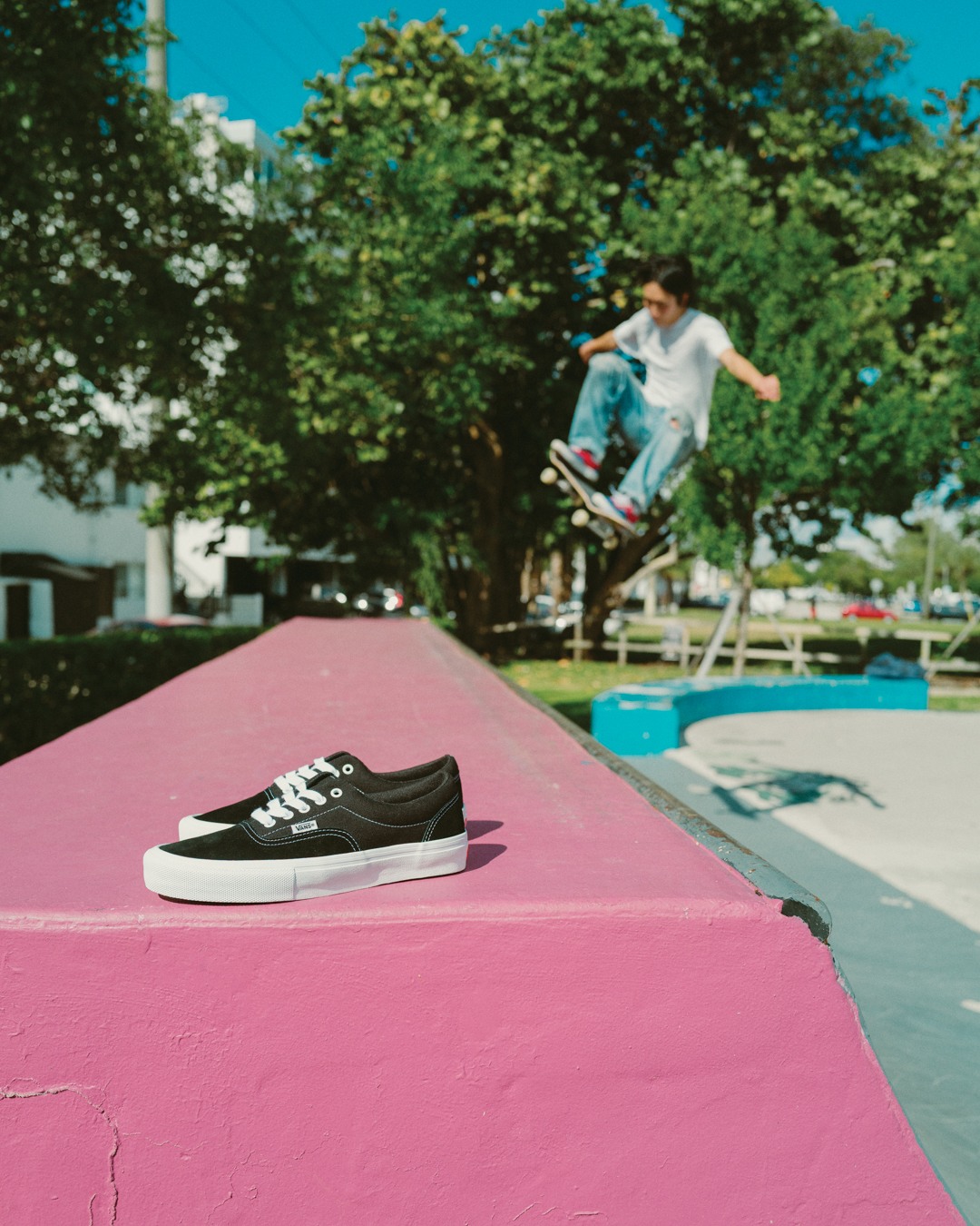 Skater airs on a small ramp with Vans Skate Eras in the foreground.