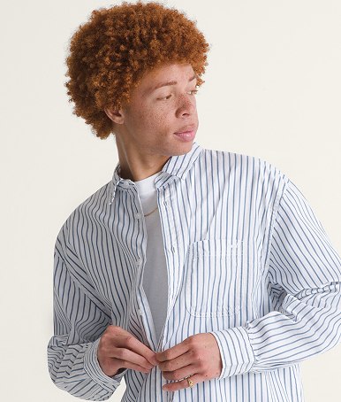 A young man wearing a white Premium Dobby Stripe Long Sleeve Shirt.