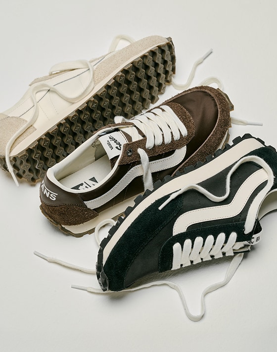 All three white, black, and brown colorways of the Premium Style 152 laid out on the floor of a photography studio.
