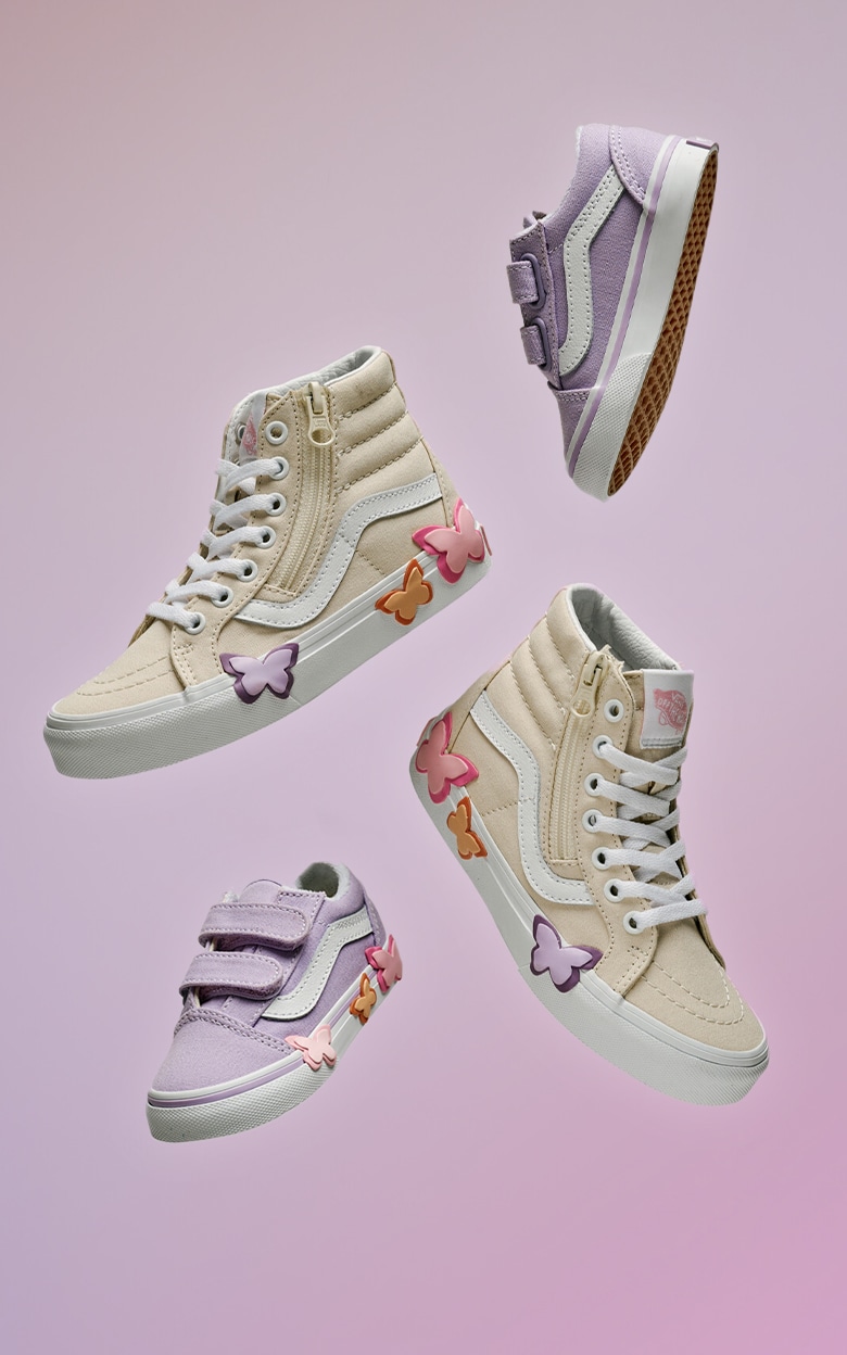 Various kids’ sizes of the Old Skool V and the Sk8-Hi Side Zip with butterfly details floating in the air against a lavender and purple background.