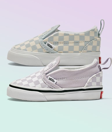 Two pairs of the Toddler Classic Slip-On V Checkerboard on a lavender and light blue background.