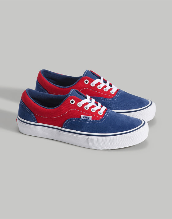 A pair of red and blue Skate Era on the floor of a photography studio.