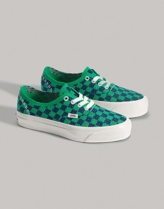 A pair of green and blue Premium Checkerboard Authentic on the floor of a photography studio.