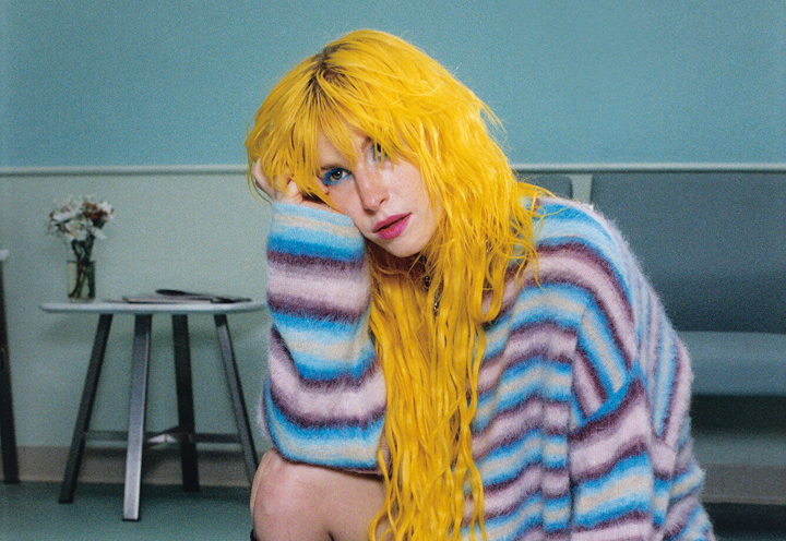 Paramore singer Hayley Williams with canary yellow-dyed hair staring off into the distance.