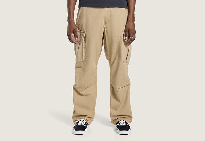 A knee-down shot of a young man wearing incense brown Range Relaxed Elastic Pants.