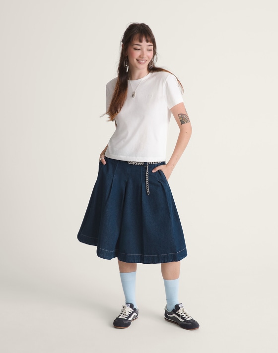 A young woman posing in a photography studio wearing the Francesca Full Skirt with black Super Lowpro shoes.